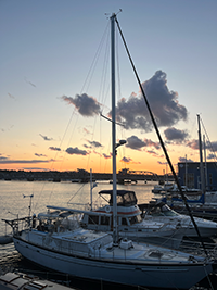 Sailboat in the harbor at sunset